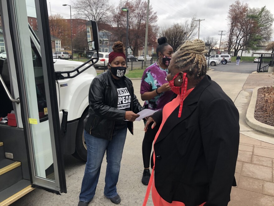 Harriett Rankin, a member of Black Lives Matter Louisville, helps residents board a van to get their second dose of the COVID-19 vaccine.