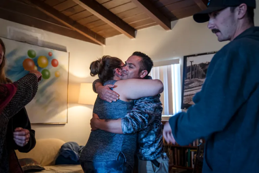 Cal Fire dispatcher Ali Wiseman and Captain Hiram Vazquez embrace during a healing session at a trauma retreat in Desert Hot Springs.