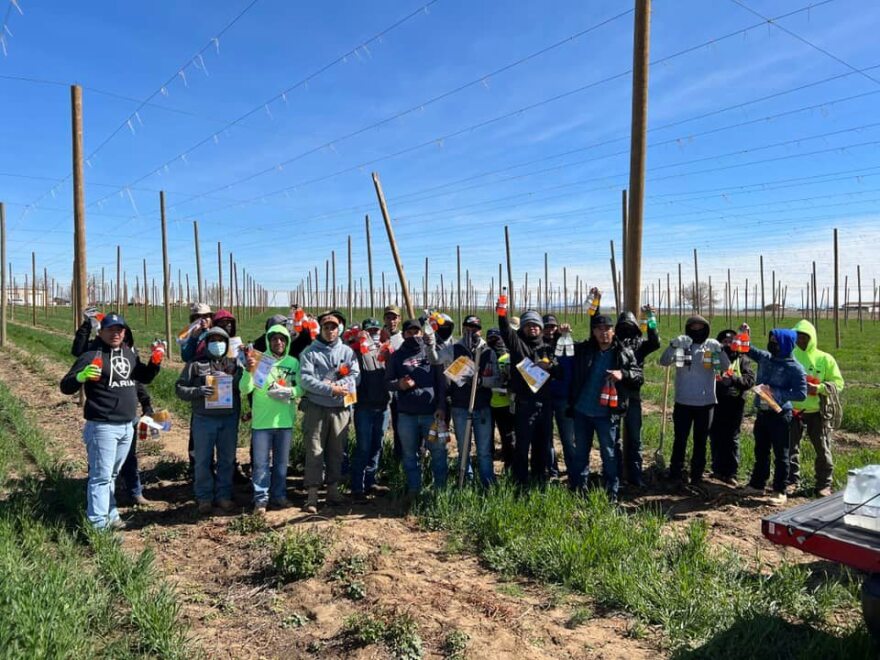Farmworkers in the Treasure Valley hold Heat and Relief Fund items from last year’s efforts. (Ricardo Godina/Idaho Immigrant Resource Alliance)