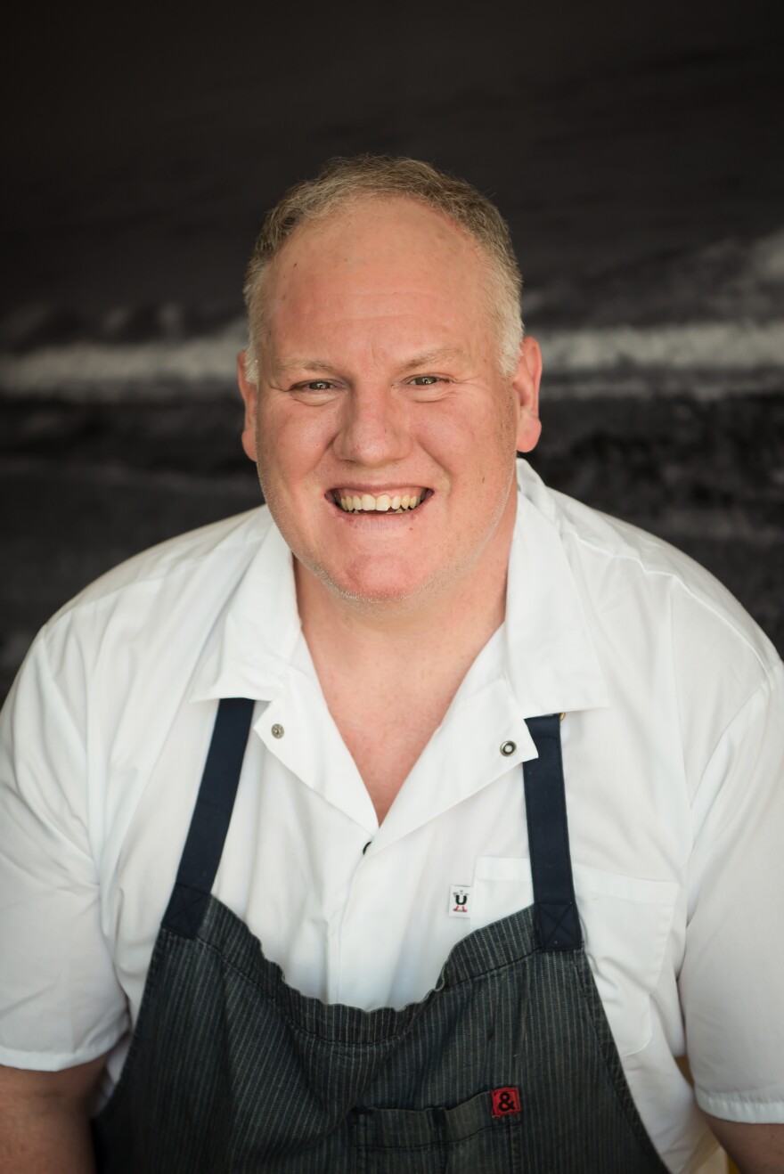 James Trees in a white shirt and black apron