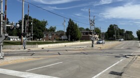 Cars pass through a railroad crossing