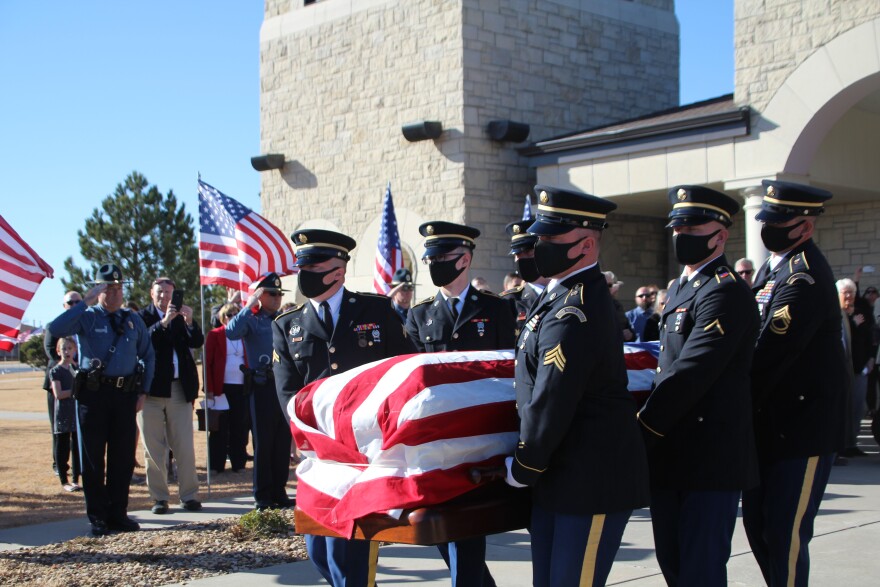 Bob Dole's casket is carried out of the church in Russell.