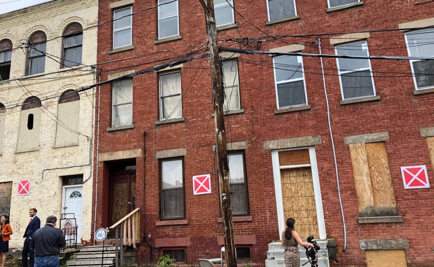 'X' Marks The Spot - three vacant buildings huddled together along Albany's Delaware Street acted as backdrop during Wednesday's presser.