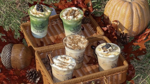 An autumn-styled setting with coffees in a basket