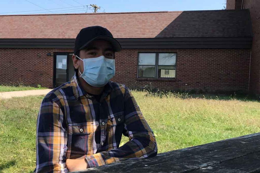 Samuel Gomez sits at the hotel where he and 100 or so other migrant farmworkers are living.