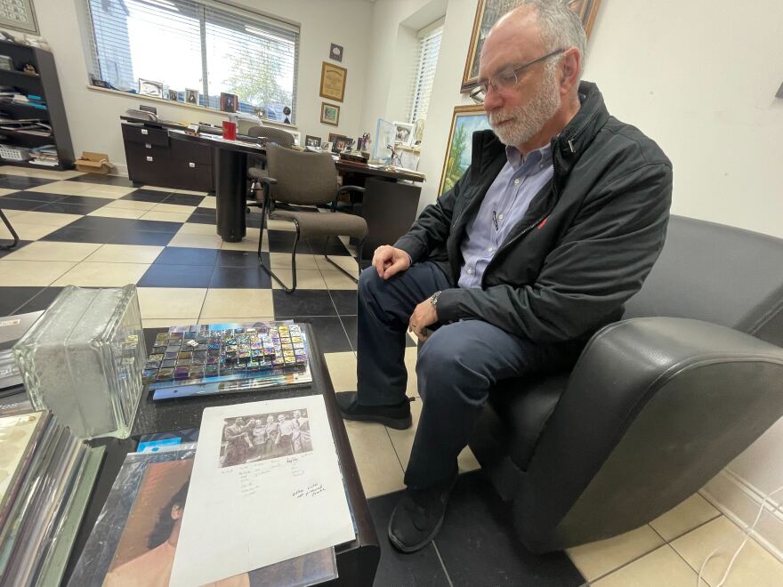 Karl Goldberg looks at family photos at the family's tile business in Columbia, S.C.