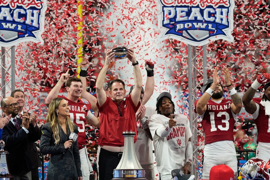 Indiana head coach Curt Cignetti holds up the trophy after the Peach Bowl NCAA college football playoff semifinal against Oregon, Friday, Jan. 9, 2026, in Atlanta. (AP Photo/Mike Stewart)