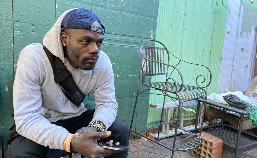Tristian Williams, 40, waits outside the Civic Media Center on Nov. 11. The pantry uses a number-based system to organize distribution. (Nicolette De Value/WUFT News)