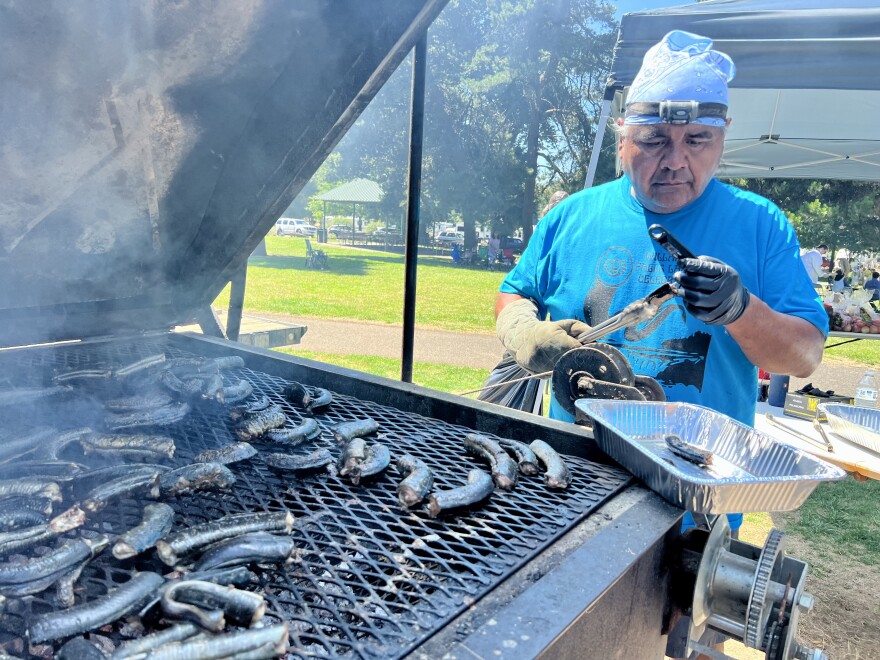 Yakama Nation member Evans Lewis grills lamprey.
