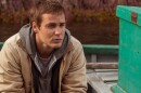 Taylor Kitsch plays Paul Lewis, a doctor in demand, in <em>The Grand Seduction</em>. It's a classic tale of an outsider discovering the appeal of a small town — except the rustic charm is manufactured for Lewis' benefit.