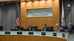Normal Town Councilmembers meet in the council chambers.