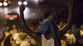 Demonstrators march towards the Ferguson Police Department on Friday to protest the killing of unarmed teen Michael Brown in Ferguson, Mo.