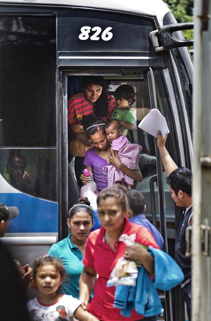 A bus carrying deportees arrives at El Edén center in San Pedro Sula, Honduras. The center receives Hondurans bused home after being intercepted in Mexico on their trek to the U.S. Mexico stepped up its deportation efforts after a wave of Central American migrants traveled through Mexico and reached the U.S. last year.