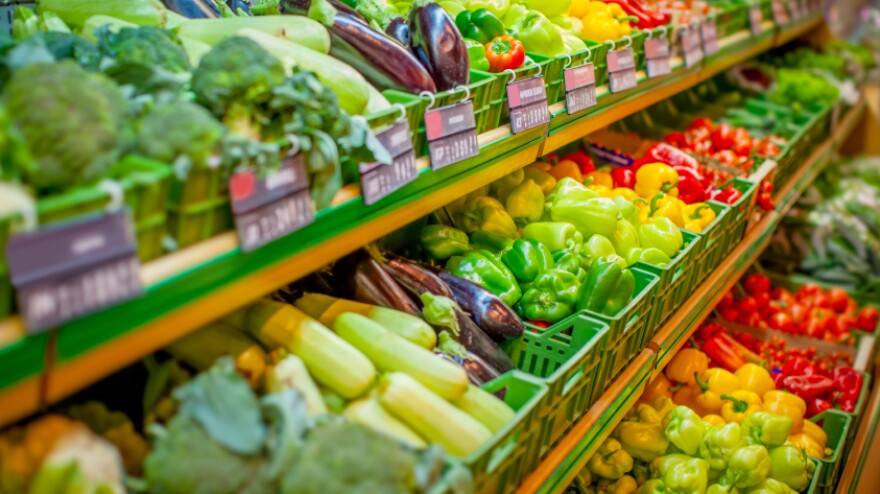 Bins of fresh produce on three shelves.