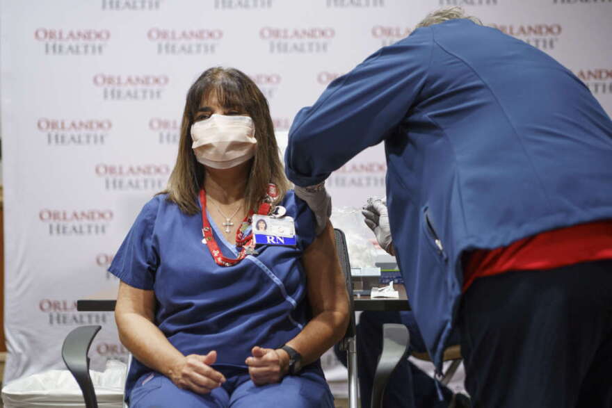 Elizabeth Rosado, RN, a 30-year veteran in the Trauma ICU unit was the first person to receive the vaccination with Orlando Health. Photo: Orlando Health