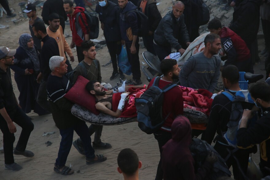 Palestinians carry the patients out of Al-Shifa Hospital in Gaza City on Monday, April 1, 2024.