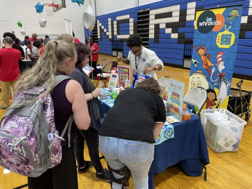 Teachers visit the WHRO Education table at a Norfolk, VA event for new teachers.
