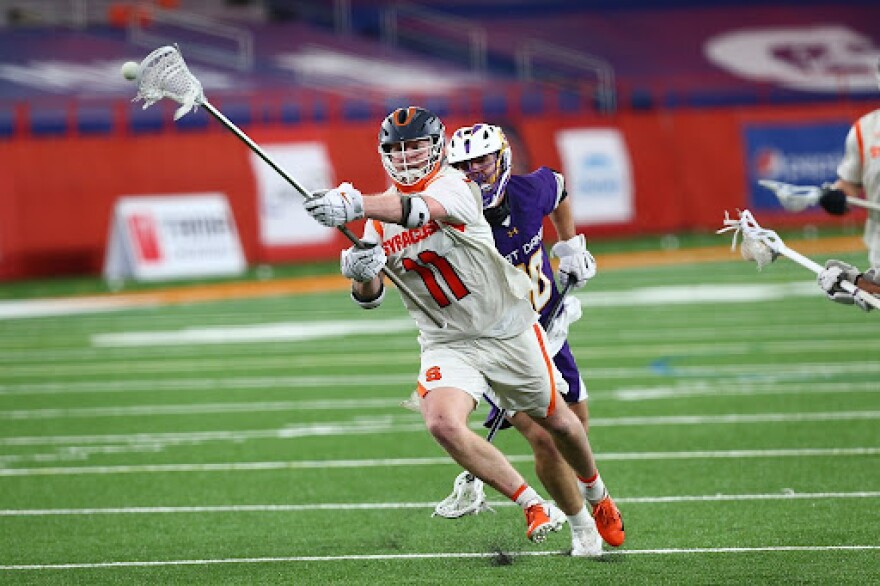 Syracuse’s Brett Kennedy (#11, White) passes the ball downfield during a 13-8 win against UAlbany on April 8, 2021.