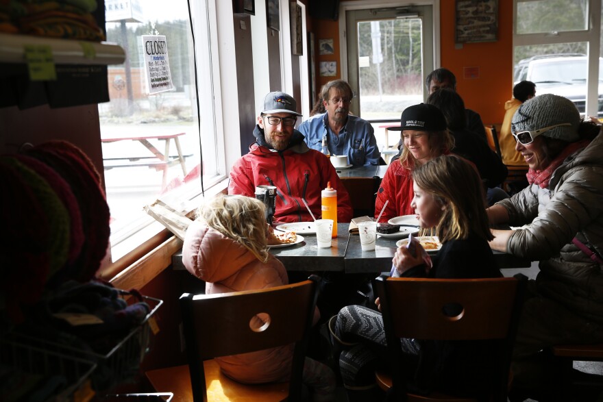 Life goes on in Haines: Friends at lunch inside Mountain Market, a cafe and grocery store.