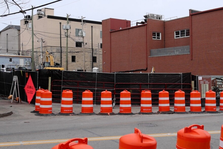 Across from the Uptown Cafe, a new apartment building is under construction.