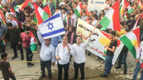 Kurds wave Israeli flags at a Kurdish independence rally. Israel is the only country in the region to support the referendum.