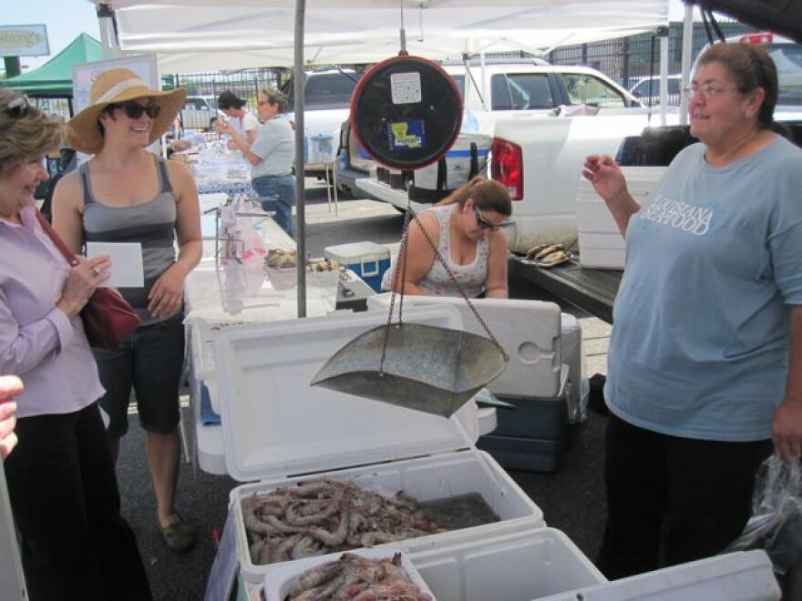 Clara Gerica (right) shares some seafood tips, and stories, at the Crescent City Farmers Market.