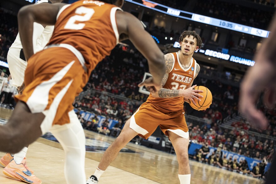 Basketball player Christian Bishop holds the ball during a Texas Longhorns game.