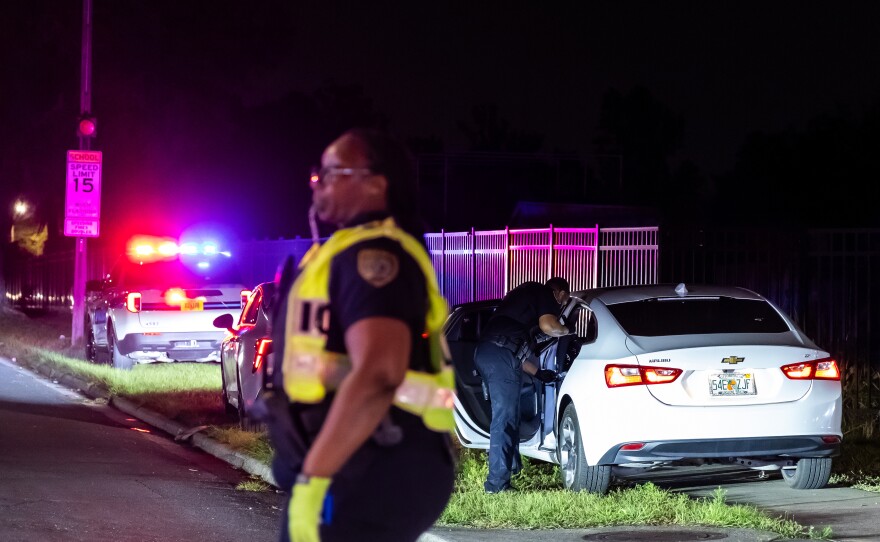 First responders direct traffic and inspect nearby vehicles while responding to a shooting at 1515 SE 15th St. on Sunday, April 20, 2025. (Madilyn Gemme/WUFT News)