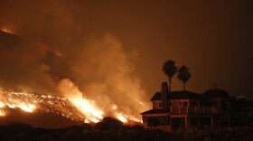 FILE - In this Tuesday, Dec. 5, 2017, file photo a wildfire threatens homes as it burns along the 101 Freeway in Ventura, Calif. Insurance claims for last year's deadly California wildfires have reached $11.8 billion, Insurance Commissioner Dave Jones said Wednesday, Jan. 31, 2018. (AP Photo/Jae C. Hong, File)