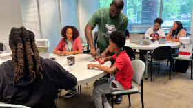 JarMarcus King, who co-owns a Williamsburg-based technology company, teaches Hampton students how to assemble a robotics kit.