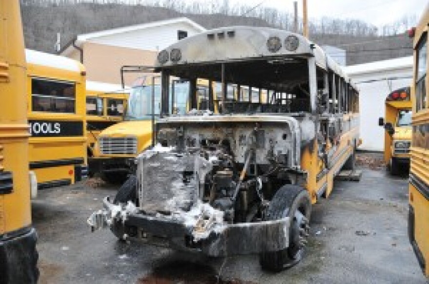 A burned-out Pike County school bus sits in the Pike County Schools transportation lot in Pikeville after catching fire early Thursday morning. School district officials believe the fire was intentionally set.