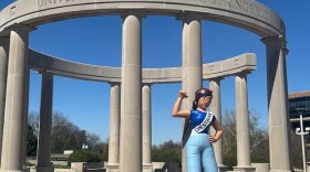 Blow up figure stands by the UIS collonade