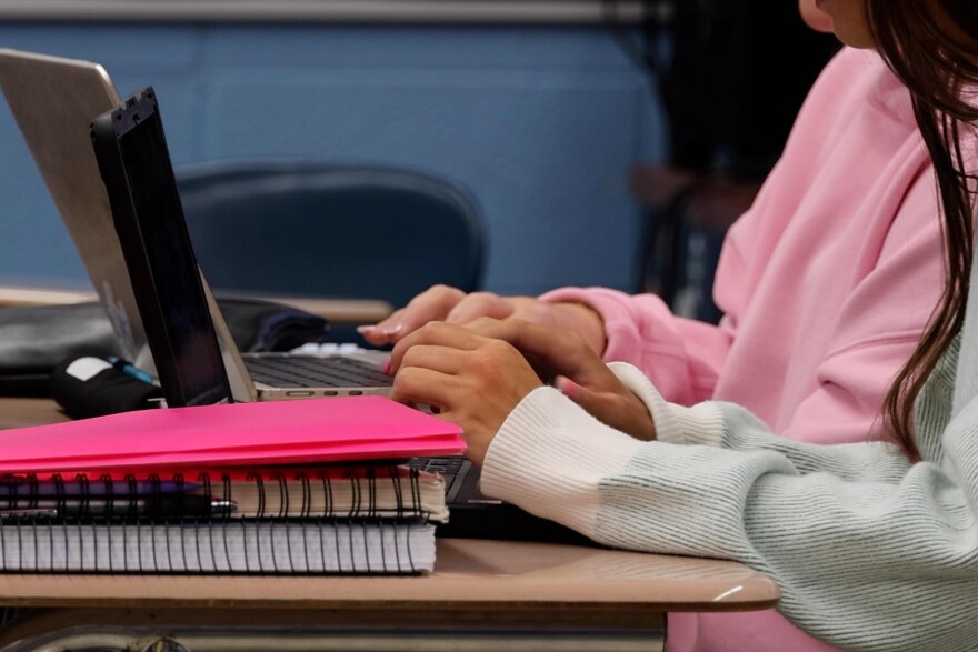 High school students type on a keyboard in an Indiana classroom.