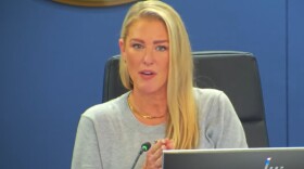 A blonde woman at a school board meeting