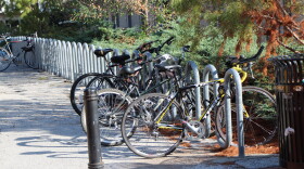 At least 4 bikes are locked at a bike rack. 