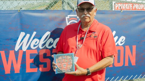 Bob Diasdado holding the example pin puzzle (Maile Palacios/KVCR Public Media)
