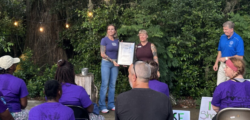 Melissa Rea, who is with the Nehemiah Project, and Emily Westerholm, executive director for Released Reentry, come together in observance of International Overdose Awareness Day. (Mackenzie Davis/WUFT News)