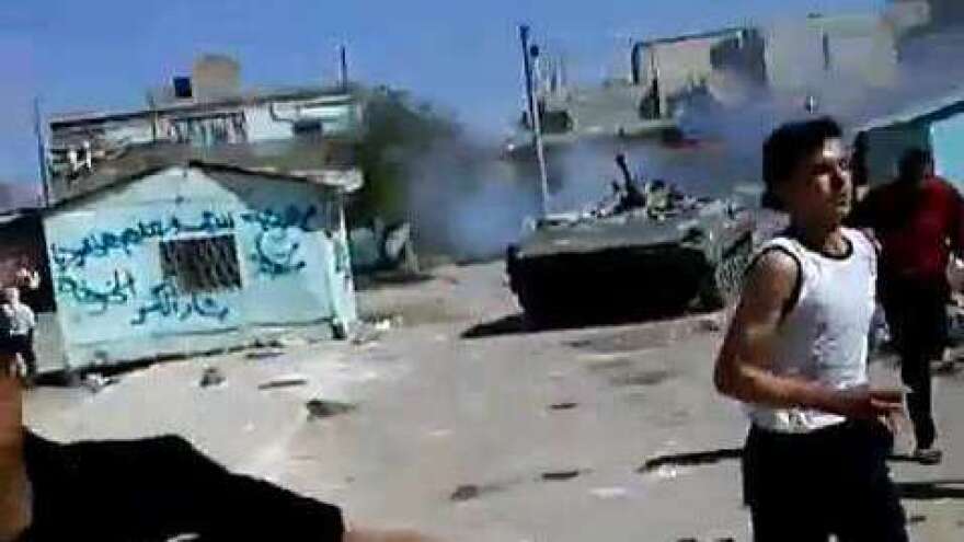 <p>In a frame grab from a YouTube video, Syrian protesters clash with an armored military in the southern Syrian town of Dera'a last Friday, according to people in the video. </p>