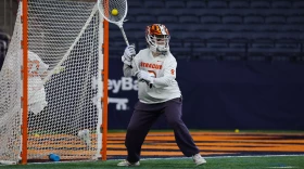 Syracuse goalie Daniella Guyette (0, White) clears the ball in No. 14 SU’s loss 13-9 loss to No. 1 North Carolina on Friday, February 13.