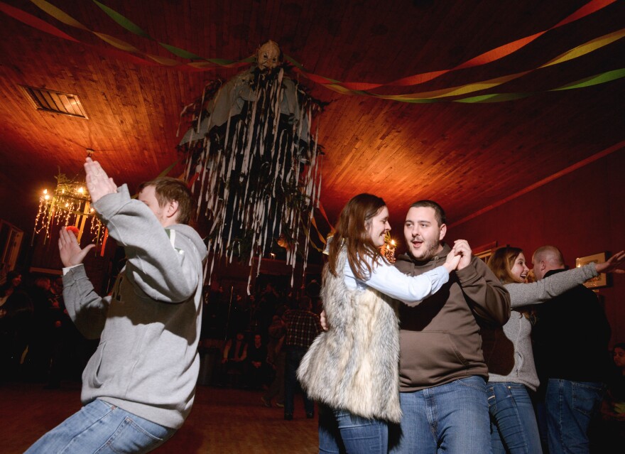 Couples square dance at the foot of the Old Man Winter effigy hanging at the center of the Community Hall. Residents and visitors to Helvetia, W.Va., celebrated Fasnacht, a pre-Lenten celebration marked by the eating of rich foods and the burning an effigy of Old Man Winter on a bonfire at midnight, Feb. 14.