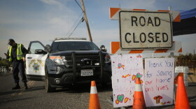 Handmade signs are seen attached to a road closure sign on Oct. 16, 2017 in Oak Knoll, Calif. (Elijah Nouvelage/Getty Images)