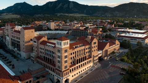 The campus of the University of Colorado Boulder, with tall buildings and red-tiled roofs. 