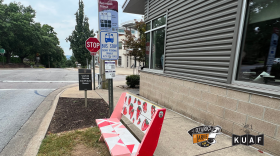 Fayetteville Strong's first bench, placed in front of KUAF Public Radio in downtown Fayetteville.