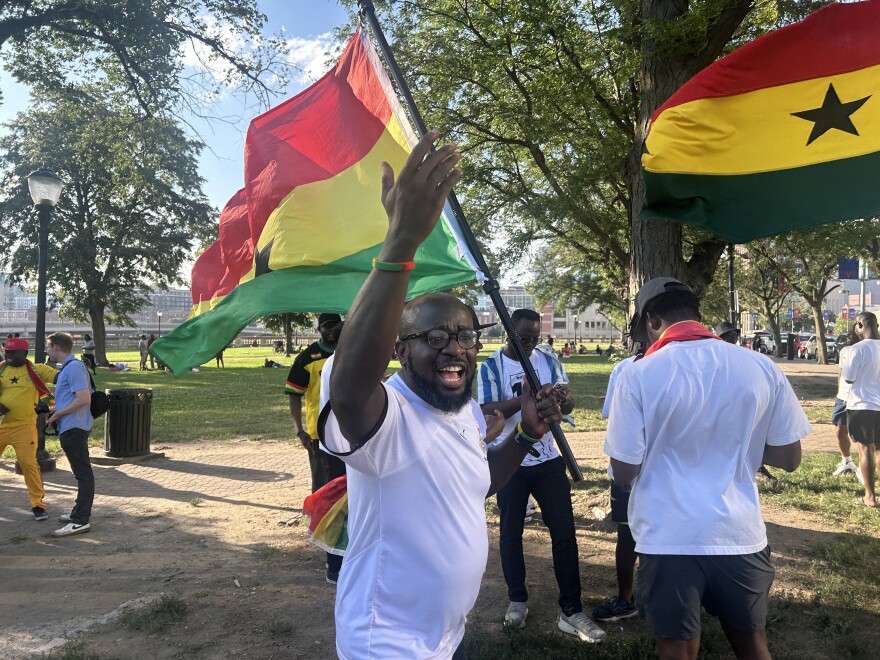 A Ghana fan pumps up others Thursday during a rally for the country's national team ahead of Friday's match against Colombia.