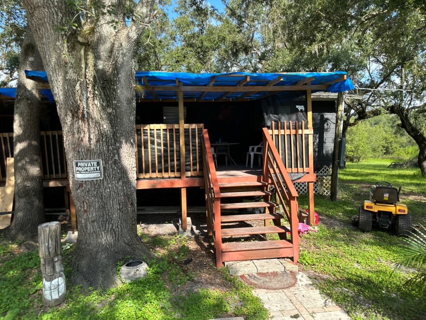 A house in rural DeSoto County sits with a damaged roof.