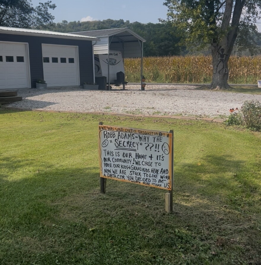A handwritten yard sign questioning the "secrecy" around a proposed hyperscale data center next door sits in a front yard on Greens Bottom Road in Carroll County.