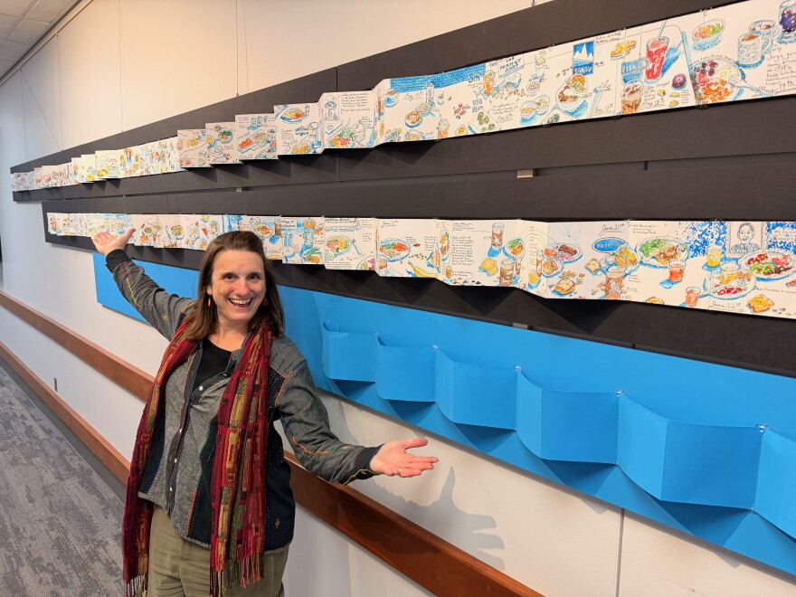Kristin Pennock in front of her winning ArtPrize entry "Sketchdiet"
