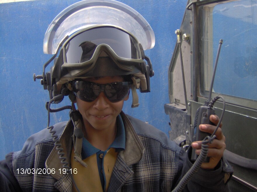 Ali, an Iraqi teenager, wears Spc. Justin Cliburn's helmet and radio equipment in Baghdad. Ali and Cliburn became unlikely friends while Cliburn trained Iraqi police in 2005 and 2006.