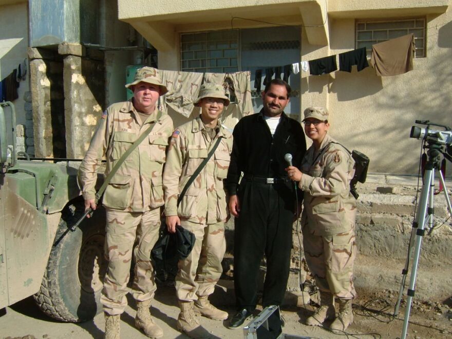 Bobby Yen, an Army Reservist serving in Iraq in 2003, with other members of his unit, and their Iraqi interpreter, wearing black.