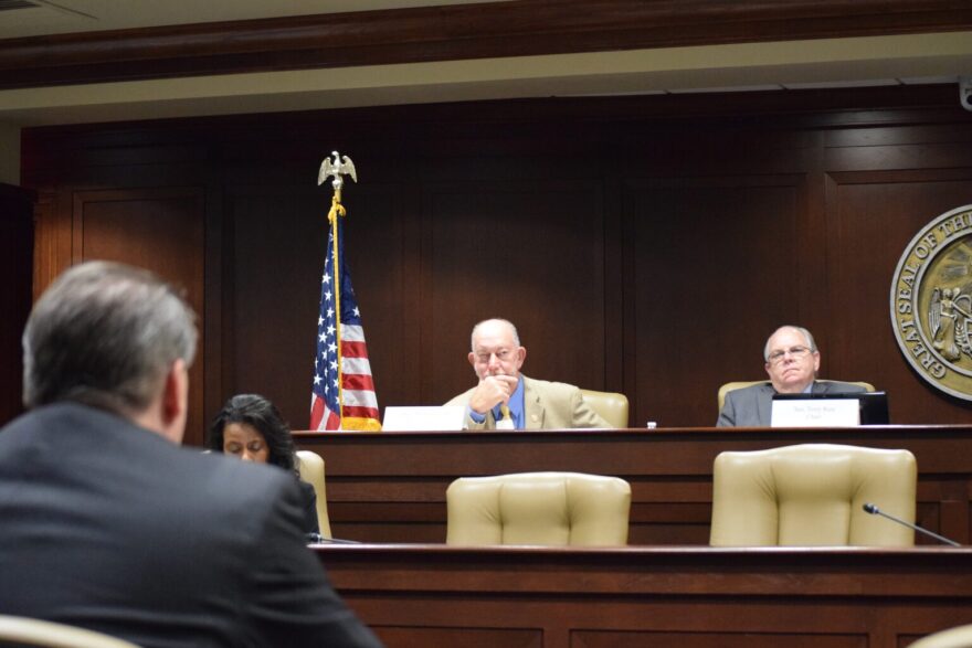 Rep. Bruce Cozart (L) and Sen. Terry Rice (R) listen to Arkansas Board of Election Commissioner Director Chris Madison discuss a new voter registration rule during a legislative committee meeting on May 2, 2024.